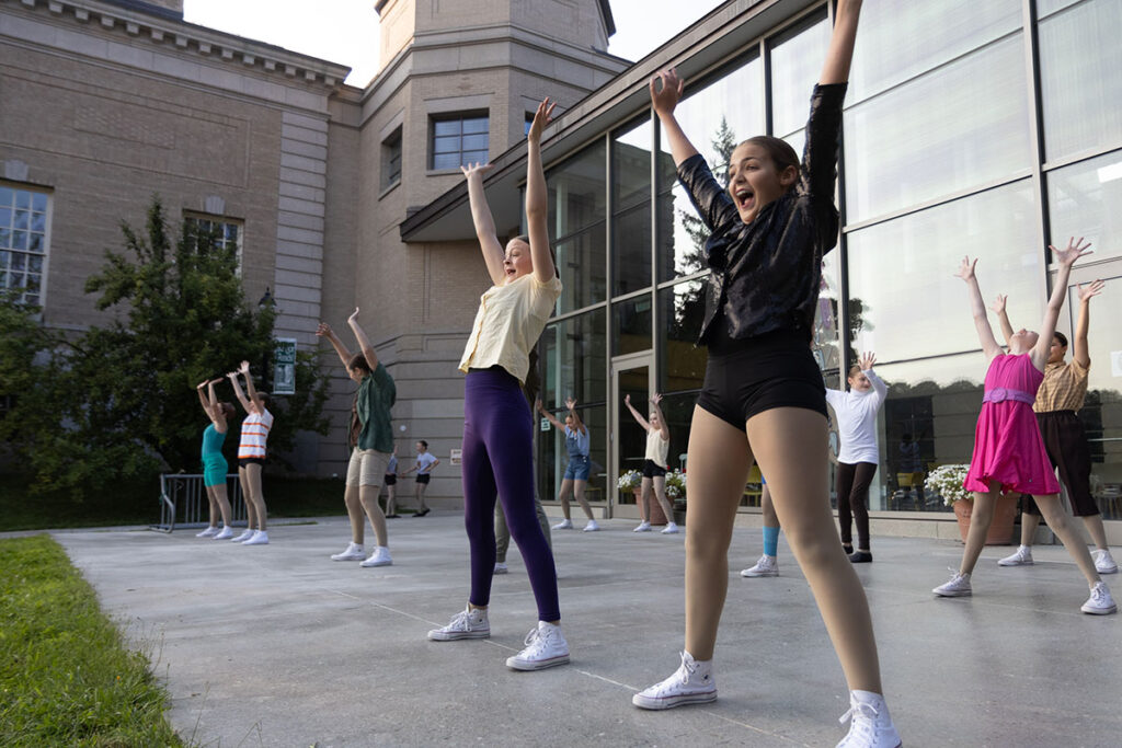 People performing a dance routine outside.